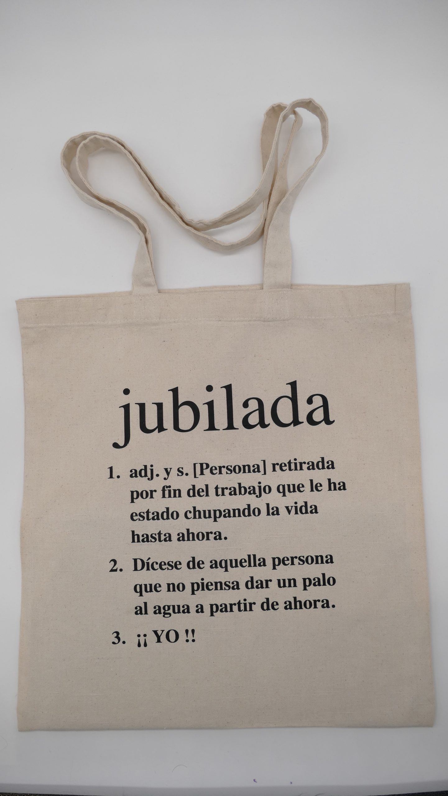Bolsa de tela con término "jubilada" y sus distintas definciones sobre fondo en blanco
